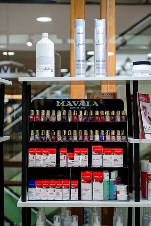 Mavala nail polish display and professional hair care product shelf inside the salon