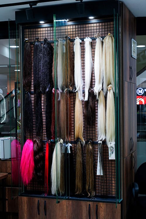 Hair extension display case with natural hair strands in various colours and lengths