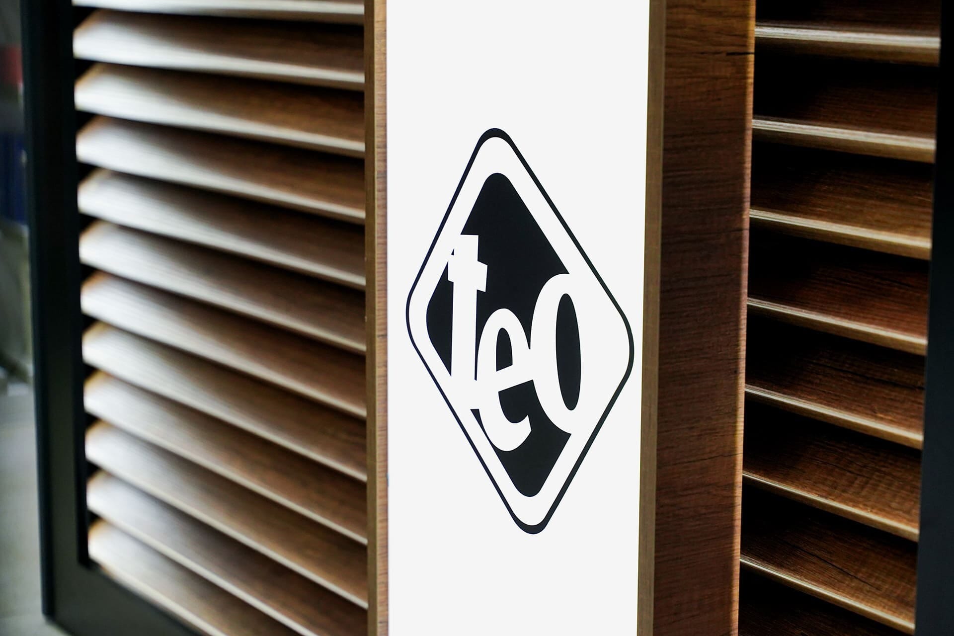 The TEO logo on the salon's wood-panelled wall