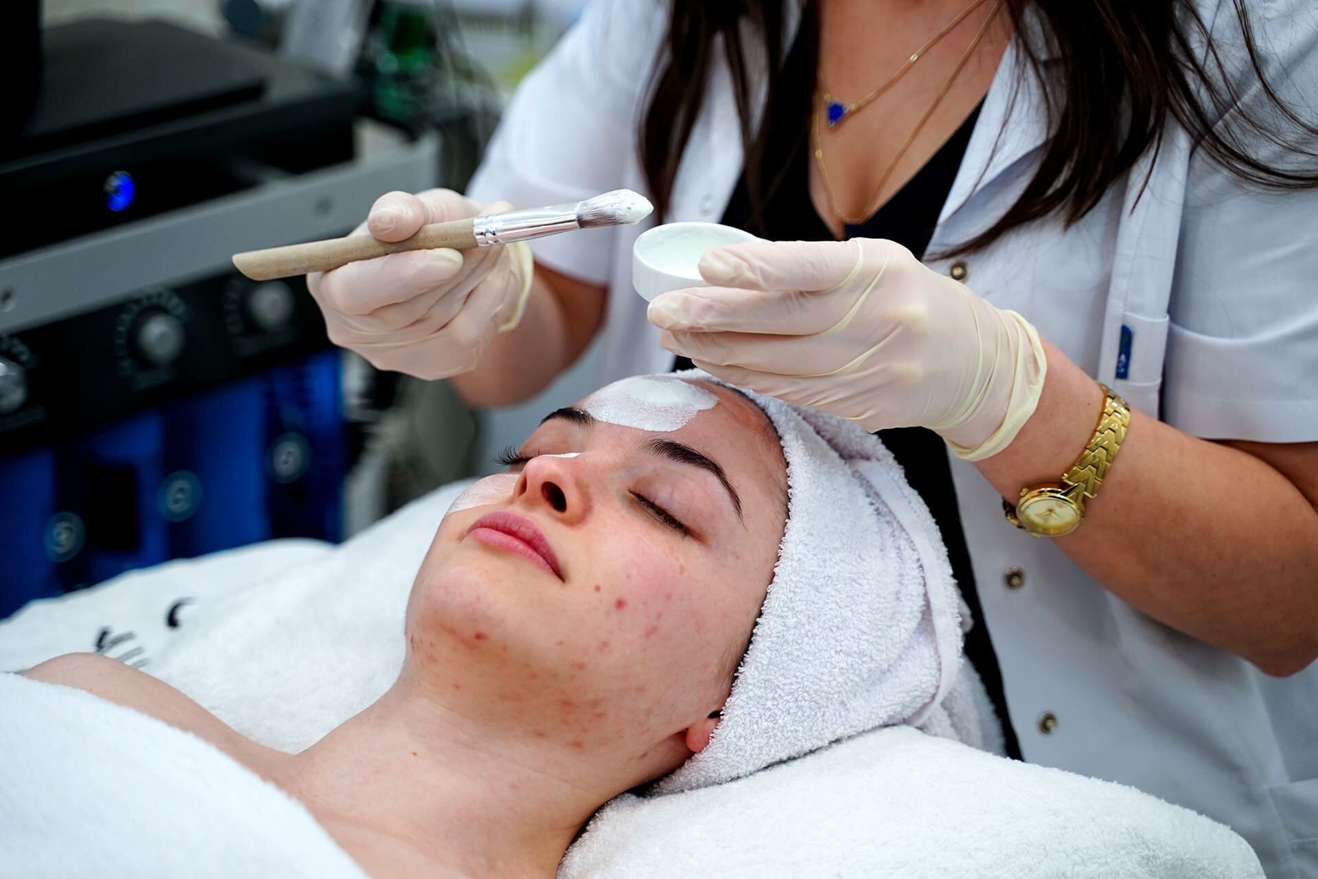 Face mask being applied with a brush during a skincare session