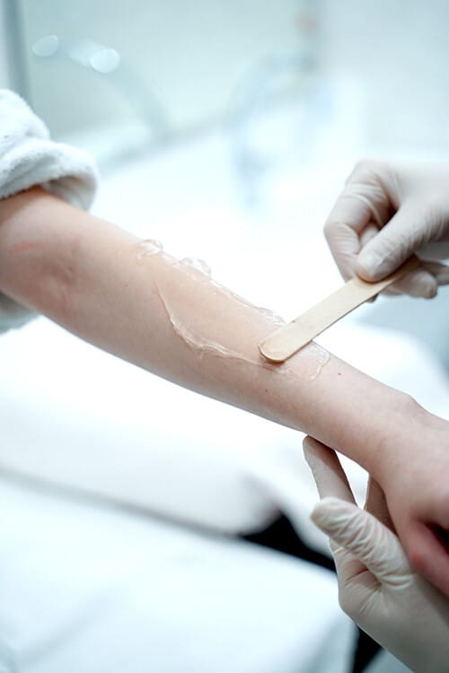 Sugar wax being applied to the forearm