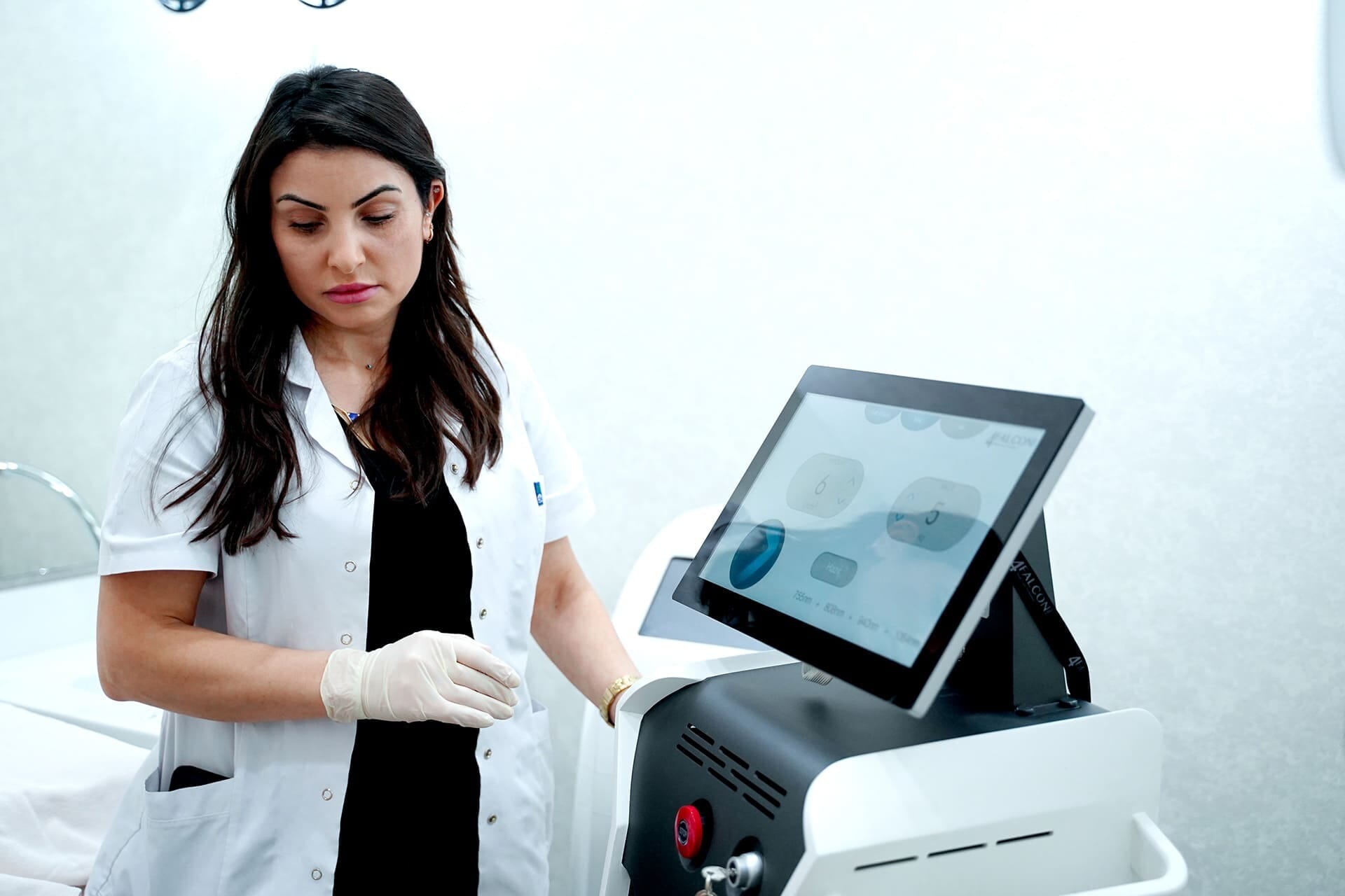 A specialist setting up the laser hair removal device