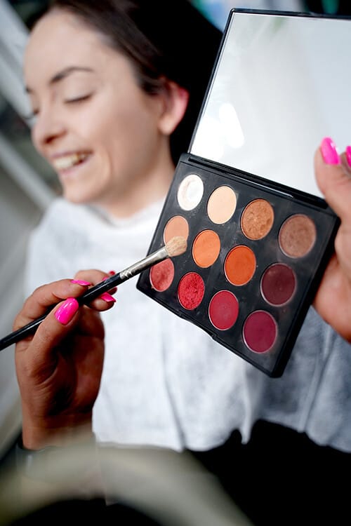 Eye make-up being applied from an eyeshadow palette