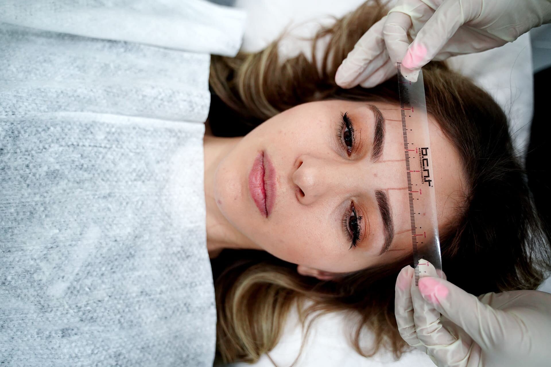 Brow mapping with a measuring ruler before brow design
